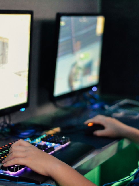 boy wearing headset playing computer game