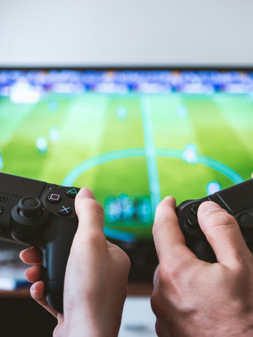 two people playing Sony PS4 game console